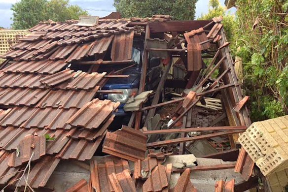 A garage collapsed on a car.