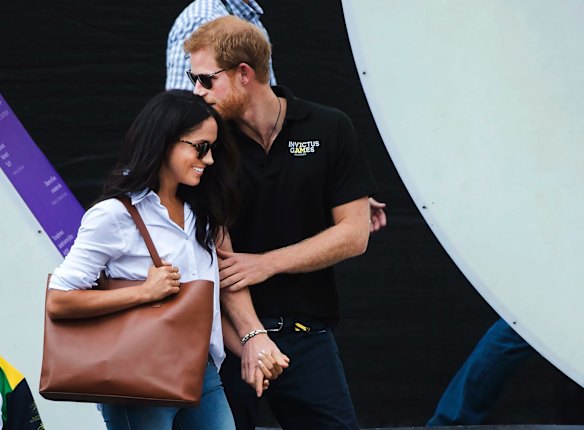 Prince Harry, right, arrives with his girlfriend Meghan Markle to wheelchair tennis during the Invictus Games in Toronto