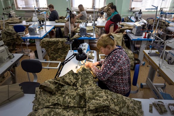 Workers sew military uniforms at a clothing factory in Kryvyi Rih. The private business, which had previously manufactured clothing brands sold throughout Europe, was refitted after the Russian invasion to produce military products.