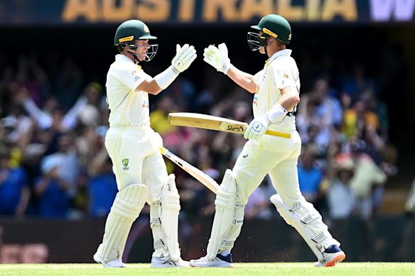 Marcus Harris of Australia and Marnus Labuschagne of Australia celebrate winning during day four of the First Test Match in the Ashes series between Australia and England at The Gabba on December 11, 2021 in Brisbane, Australia. 