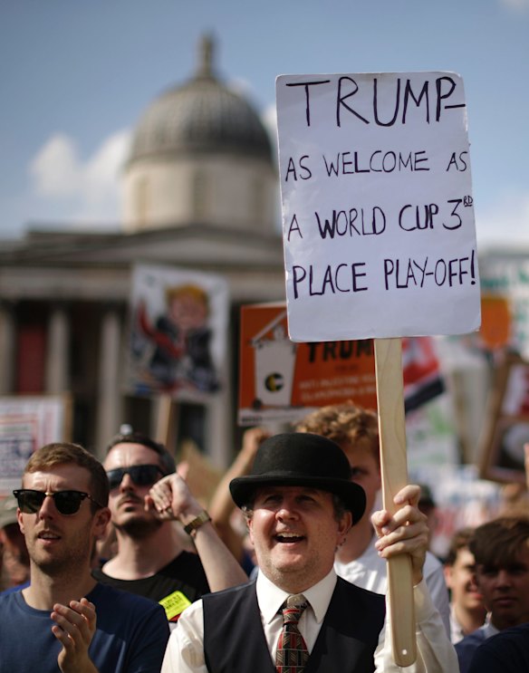 'Trump - As Welcome As A World Cup 3rd Place Play-Off'. Protesters holding banners gather after a march opposed to the visit of U.S. President Donald Trump in Trafalgar Square in London, Friday, July 13, 2018. 