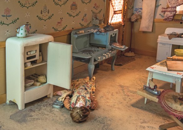 Kitchen (c.1944–1945). Dimensions: 43.25 x 64 x 63cm.
Reported to Nutshell Laboratories Wednesday, 12 April 1944.
Barbara Barnes, a housewife, was found dead by police who responded to a call from the husband of the victim, Fred Barnes, who gave the following statement:
About 4pm on the afternoon of Tuesday, 11 April 1944, he had 
gone downtown on an errand for his wife. He returned about an hour and a half later and found the outside door to the kitchen locked. It was standing open when he left. Mr Barnes 
attempted knocking and calling, but got no answer. He tried the front door, but it was also locked. He then went to the kitchen window, which was closed and locked. He looked in and saw what appeared to be his wife lying on the floor. He then summoned the police.
The model shows the premises just before the police forced open the kitchen door.