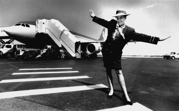 Flight attendant Helen Corney pictured near a Compass Airways jet at Brisbane Airport 