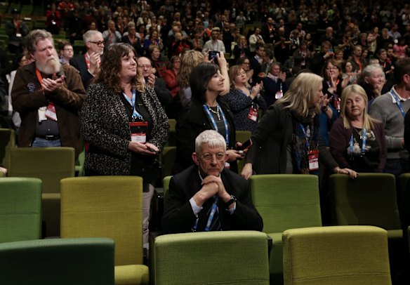 Union figure and same-sex marriage opponent Joe de Bruyn remains seated while Senator Wong is given a standing ovation.