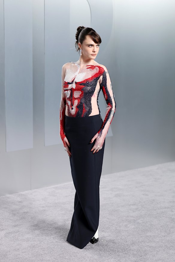 Cara Delevingne in a nude illusion top.