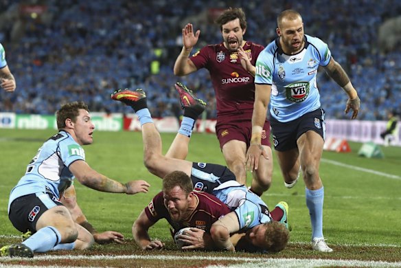 Gavin Cooper of the Maroons scores a try.