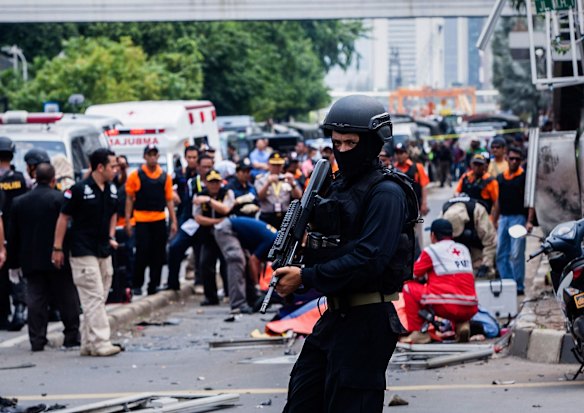  An Indonesian policeman stands guard in front of a blast site at the Indonesia capital Jakarta on January 14, 2016 in Jakarta, Indonesia.