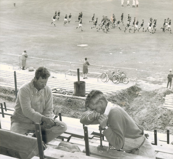 While the Saints went marching out to their practice match on their new ground at Moorabbin in 1965, workers were completing construction on the grandstand.