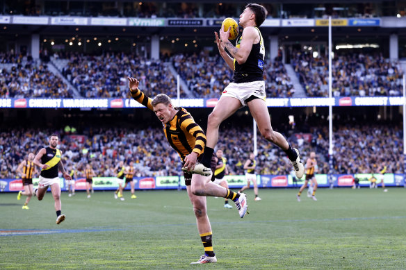High flyer: Richmond’s Jacob Bauer takes a spectacular mark on an otherwise tough day for the yellow and black.