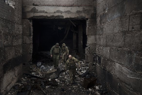 Ukrainian soldiers inspect a building previously used by Russian soldiers as a temporary base in Malaya Rohan, on the outskirts of Kharkiv.