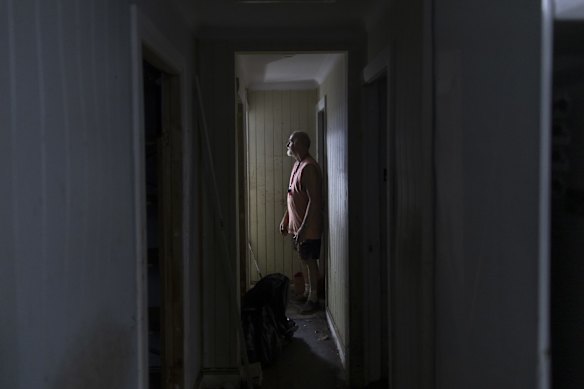 Ray Rendell stands among the ruins of his home in Lismore after flooding reached the second storey. 