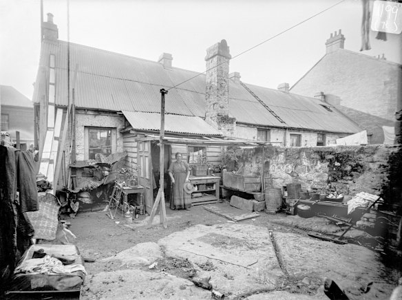 1 Church Street, Pyrmont, c1901. A woman stands next to a timber lean-to at the back of a 5-roomed stone cottage at 1 Church Street, Pyrmont. This street was at the tip of Pyrmont peninsula, overlooking Jones Bay. The backyard is a quarried sandstone platform, typical of the geological landform of this area. In 1902, the council issued an order for the tenant and owner to demolish the building.