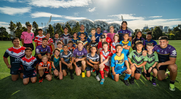 Players from across NRL Victoria and the Storm pathways pose with Storm captain Harry Grant (front row, middle).