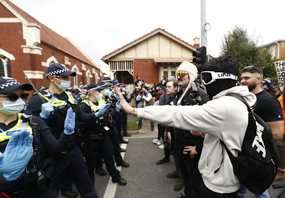 A protester argues with police on Burnley Street, Richmond in Melbourne.