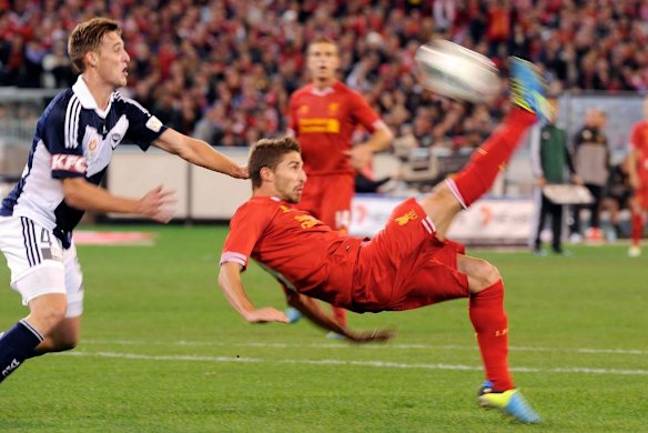 Liverpool's Fabio Bonini kicks for goal over Nick Ansell.