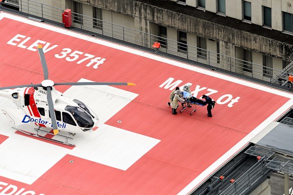 In this aerial image, former Prime Minister Shinzo Abe is on a stretcher to a helicopter after being shot in front of Yamatosaidaiji Station while making a street speech for upcoming Upper House election.