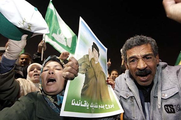 Supporters of Libyan leader Moamer Kadhafi shout slogans during a pro-government rally in Tripoli after an opposition "day of anger" became a bloodbath.