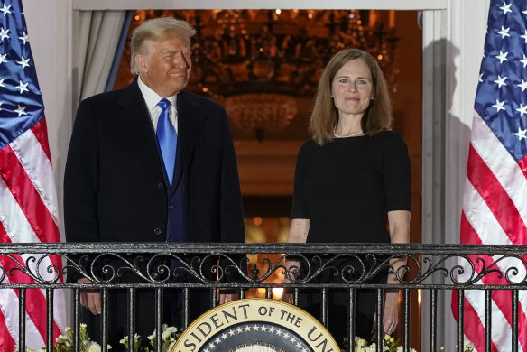 President Donald Trump and Amy Coney Barrett stand on the Blue Room Balcony in 2020 after she was sworn in as a Supreme Court judge.