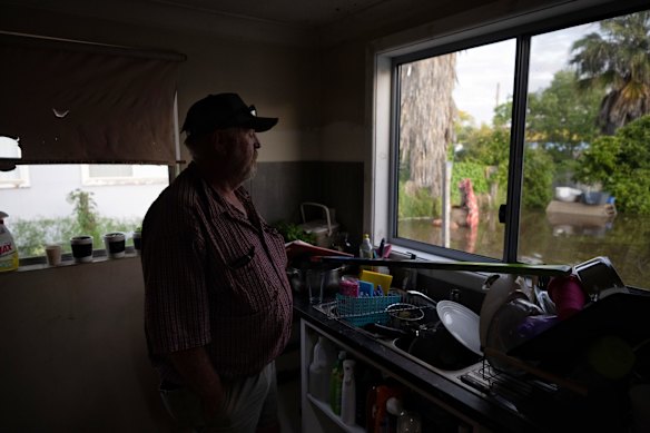 Bali Bombing survivor John Shaw looks out at the ocean of flood water surrounding his house, Saturday November 5, 2022.