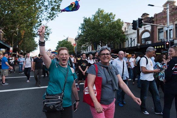 Crowds march down Oxford St, Darlinghurst this evening to celebrate the majority yes vote of the results of the postal vote.
