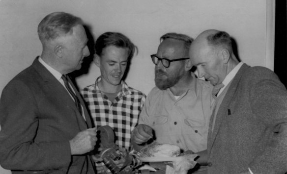 “A sample of flesh from the Tasmanian ‘monster’ is examined in Hobart by (l-r) Mr Cramp, Mr T. Kingston, a TV cameraman, Mr Mollison and Mr M. Bennett, a member of the first expedition to examine the creature.” March 16, 1962.