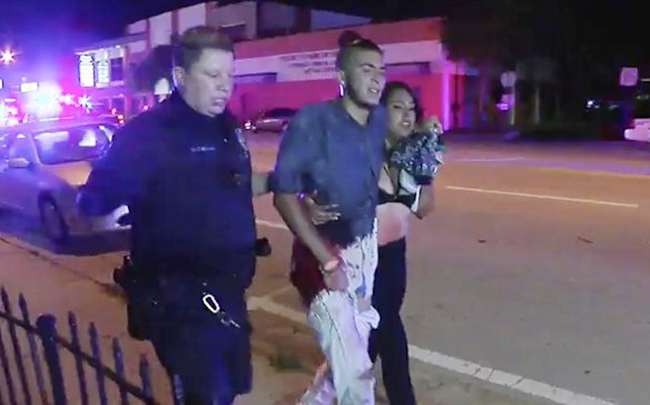 An injured man is escorted out of the Pulse nightclub after a shooting rampage.
