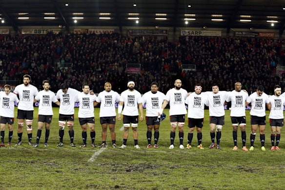 Players of Oyonnax and Montpellier observe a minute of silence for Charlie Hebdo and wear shirts reading in french "we are all Charlie" before the start of the French Top 14 rugby union match between Oyonnax (USO) and Montpellier (MHR) on January, 2015 at the Charles-Mathon Stadium in Oyonnax.