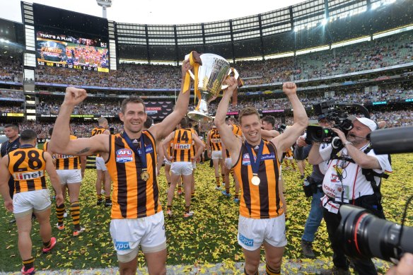 Glory days: Club greats Luke Hodge and Sam Mitchell are now influencing the new breed of Hawks, including Peter Crimmins medallist Will Day.