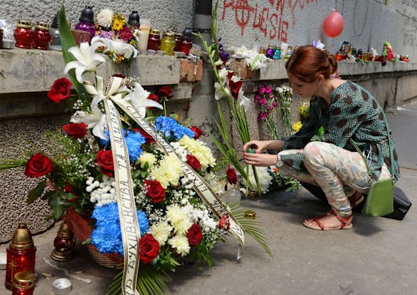 A girl sets a candle at the Netherlands Consulate in Lviv on July 18, 2014, to commemorate passengers   of Malaysian Airlines flight MH17 carrying 295 people from Amsterdam to Kuala Lumpur which crashed in eastern Ukraine.  Ukraine's prime minister said Friday that pro-Russian separatist rebels who Kiev believes shot down a Malaysian airliner with 298 people on board should face an international tribunal in The Hague.