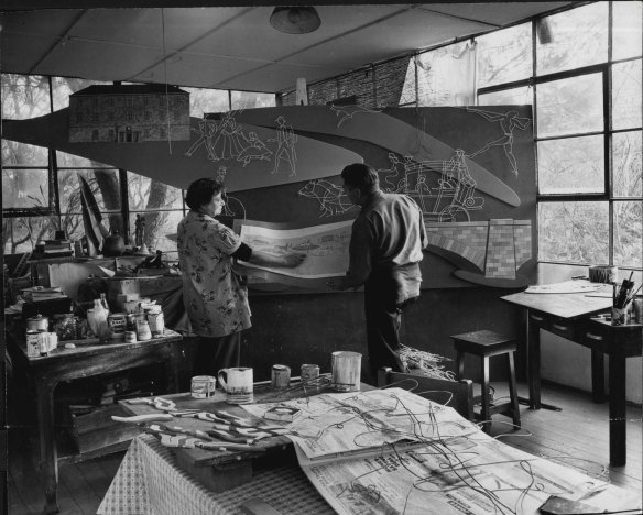Roma Hilder and her husband, Bim Hilder, assembling the mural of the first Easter Show which they have designed for the staff restaurant at Grace Brothers, Parramatta. June 10, 1957. 