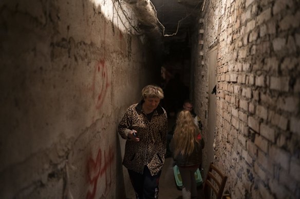 Helena walks inside the basement of a residential building during a Russian attack in Lyman. The 60-year-old woman says it's a very difficult moment. All residents of the building are living in the basement. "They hit us endlessly with rockets".