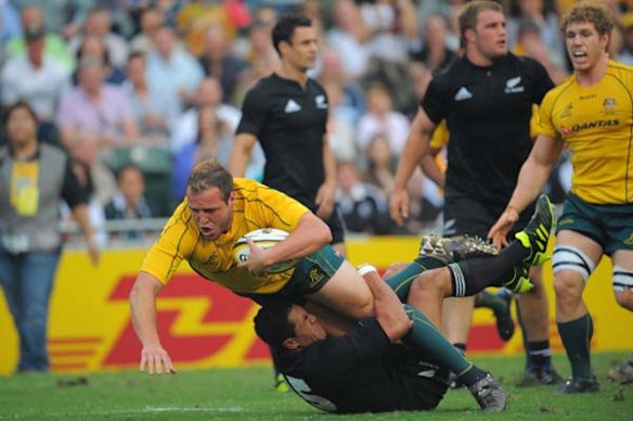 Ben Alexander is tackled by Mils Muliaina.