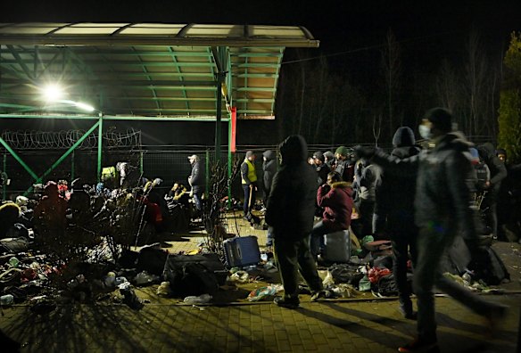 People wait to reach the passport control office on the Ukrainian side of the Medyka border crossing on the Ukrainian-Polish border.