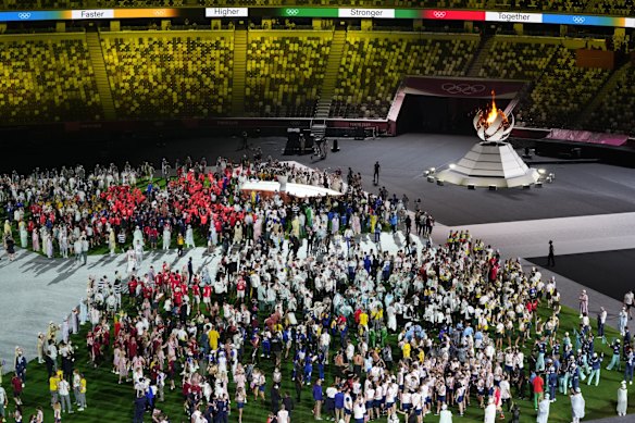 Athletes arrive for the closing ceremony in the Olympic Stadium at the 2020 Summer Olympics in Tokyo, Japan.