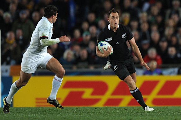 All Blacks full-back Israel Dagg runs with the ball next to France's Francois Trinh-Duc.