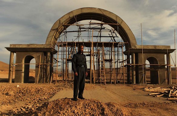 Uruzgan Police Chief, Matiullah Khan stands infront of the arched gateway construction he is privately building on the Tarin Kowt to Kandahar Highway, at the entrance to Tarin Kowt town.