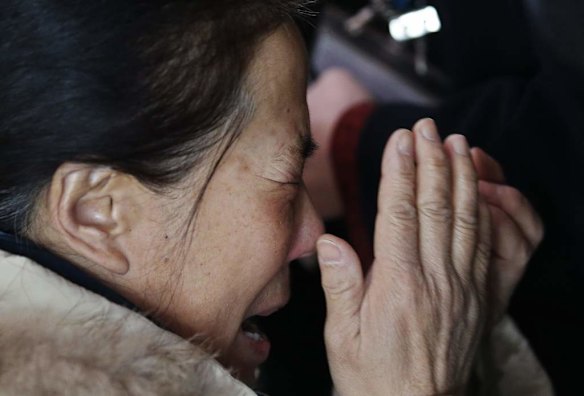 A relative of a passenger onboard Malaysia Airlines flight MH370 cries at the Beijing Capital International Airport in Beijing.