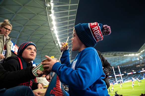 Supporters attend the first game at the rebuilt stadium.