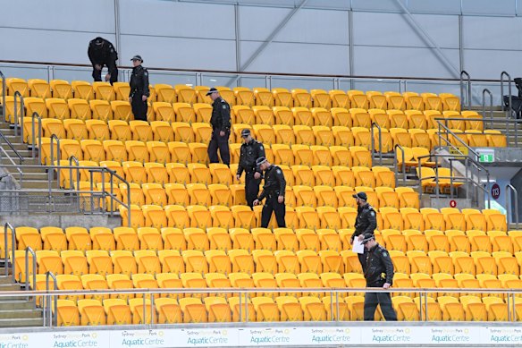 Police check the stands before the arrival of Prince Harry at the Sydney International Aquatic centre. 