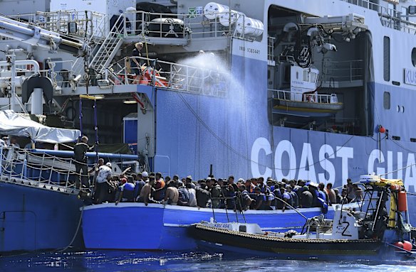 Some of the 441 refugees attempting to cross from Libya to Europe on a wooden boat are rescued by the Swedish Coast Guard off the Libyan shore.