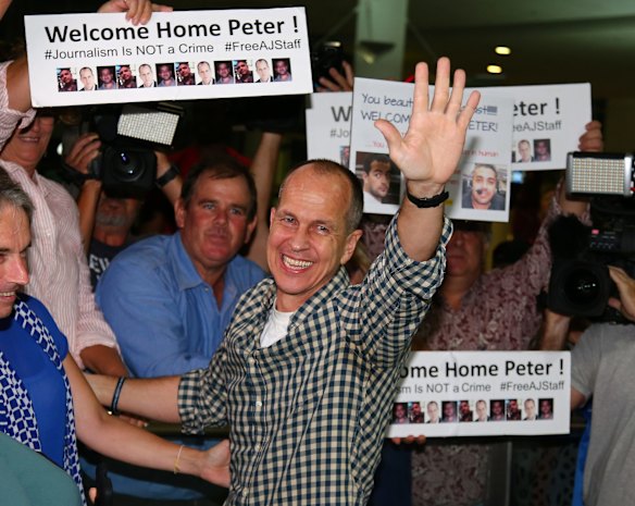 Peter Greste greets his supporters and the media after landing back in Australia at Brisbane Airport.