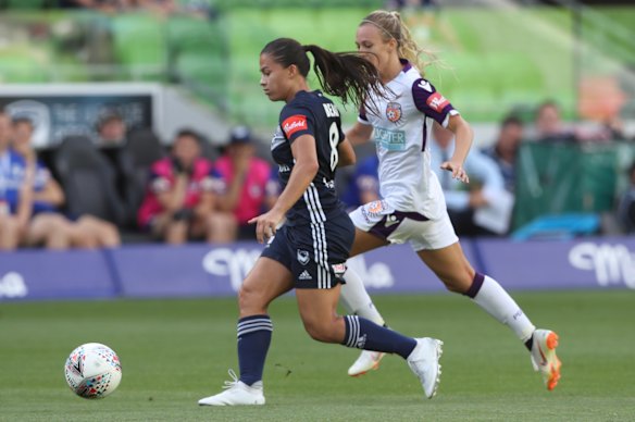 Angela Beard controls the ball for Victory.