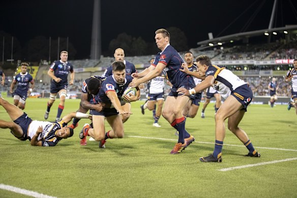 The Brumbies' Tevita Kuridrani tries to stop the Rebels' Jack Maddocks as he heads for the corner post. 