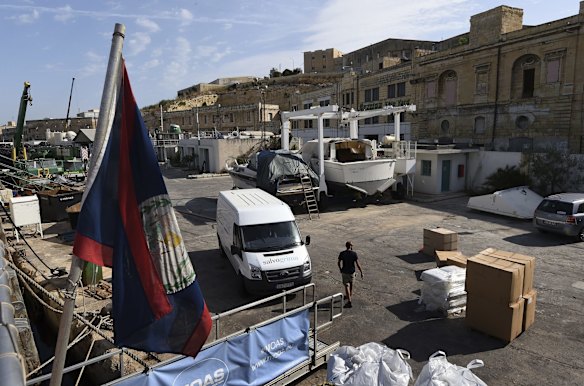 A man walks amongst the cargo for the MY Phoenix, a rescue boat operated by Migrant Offshore Aid Station (MOAS) with the support of Medecins Sans Frontieres that is docked at Coal Wharf in Malta prepares before sailing to the search and rescue zone.