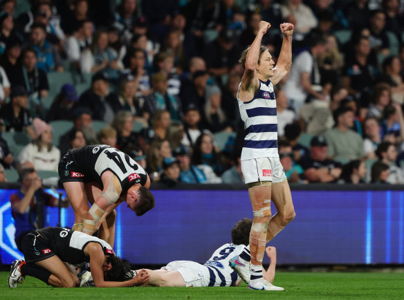 Agony and ecstasy: Rhys Stanley celebrates on the siren as Port players hang their heads.