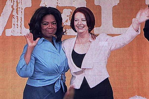 Talk show queen Oprah Winfrey appears on stage with Prime Minister Julia Gillard.