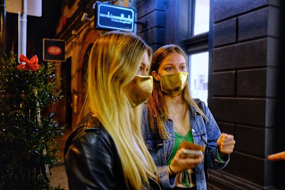 Holders of tickets for a midnight haircut waiting outside South Yarra’s Joey Scandizzo Salon. 