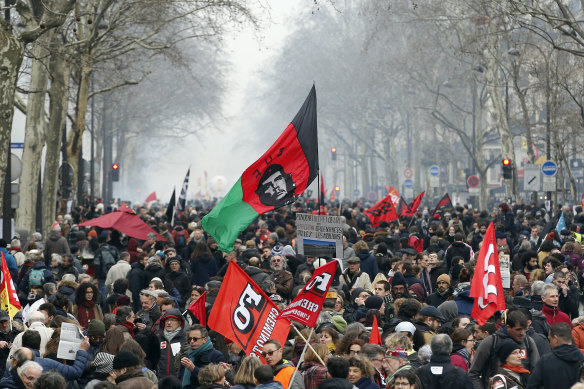 Demonstrators marching in  Paris, France, in support of railway workers
