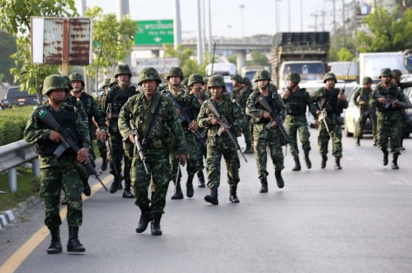 Thai soldiers move in to a pro-government demonstration site.