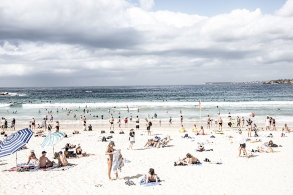 Hundreds of people defied social distancing measures and flocked to Bondi for a dip or a sunbake